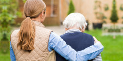 caregiver assists the senior woman for walking