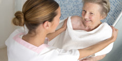 caregiver assists the senior woman for bathing