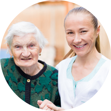 senior woman with white hair and her caregiver smiling